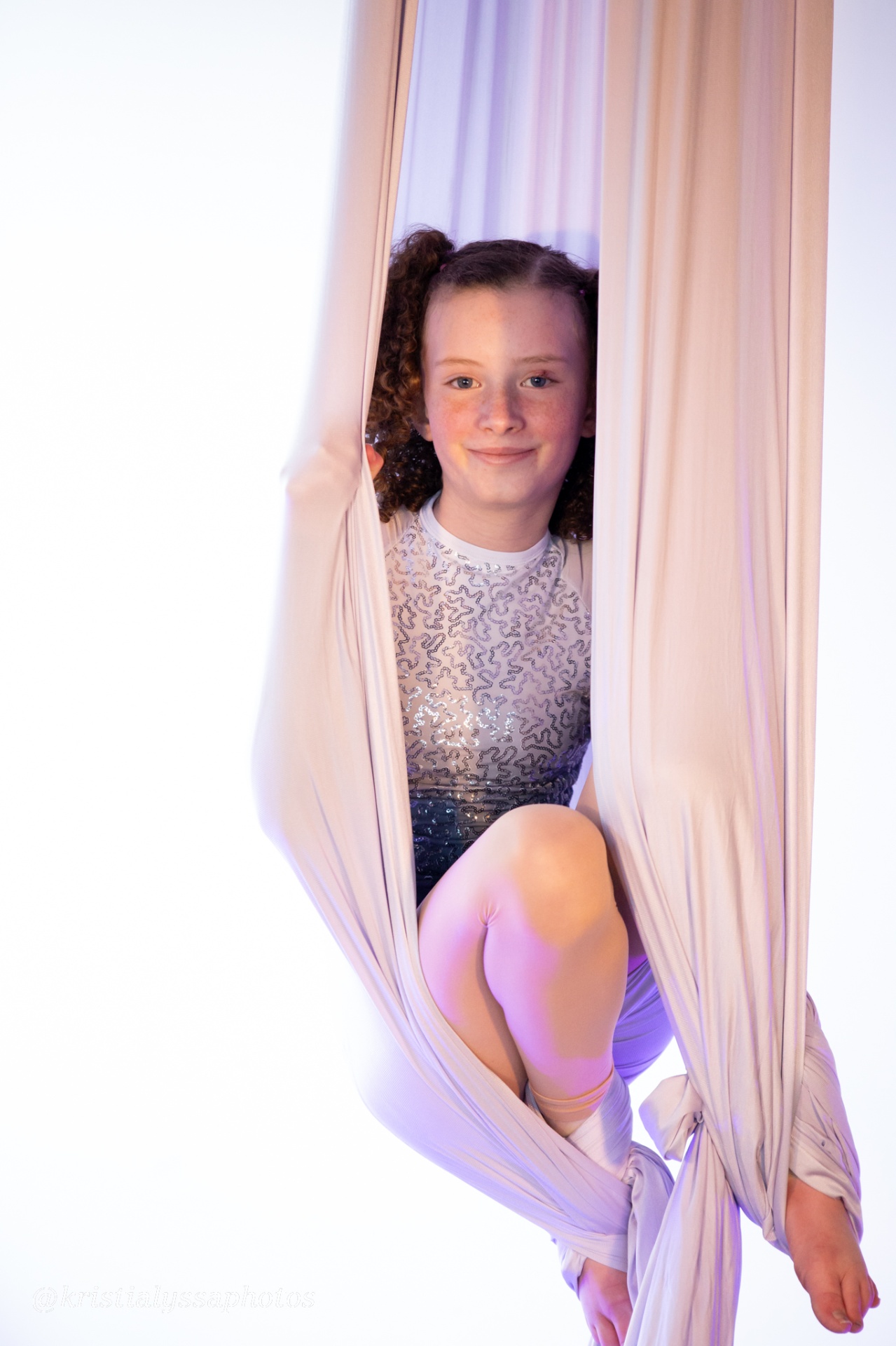 Performer cocooned in silks